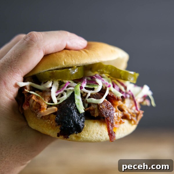 Smoked Pork Loin Recipe for Tender, Flavorful Meat 16 Pulled pork sandwich made from smoked pork butt with pickles, slaw, and BBQ sauce