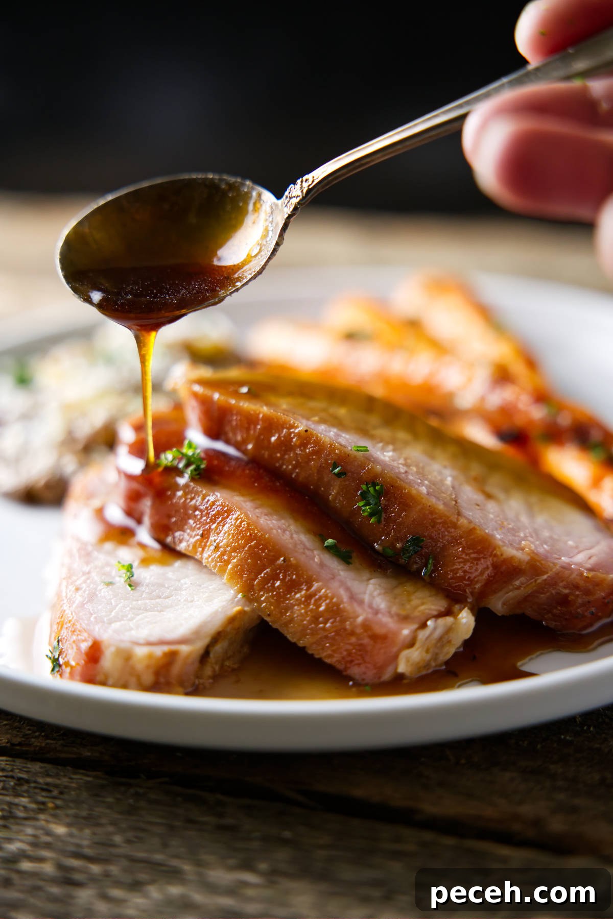 Smoked Pork Loin Recipe for Tender, Flavorful Meat 3 drizzling glaze on sliced pork loin
