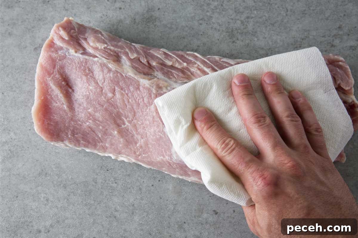 Smoked Pork Loin Recipe for Tender, Flavorful Meat 7 patting dry a pork loin