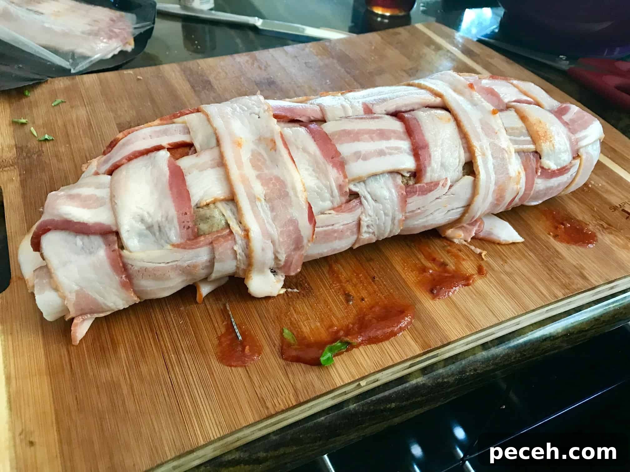 Bacon Explosion Pizza Roll: The Original Pizza Fatty Recipe 6 Pizza Bacon Explosion rolled up on wooden cutting board side view