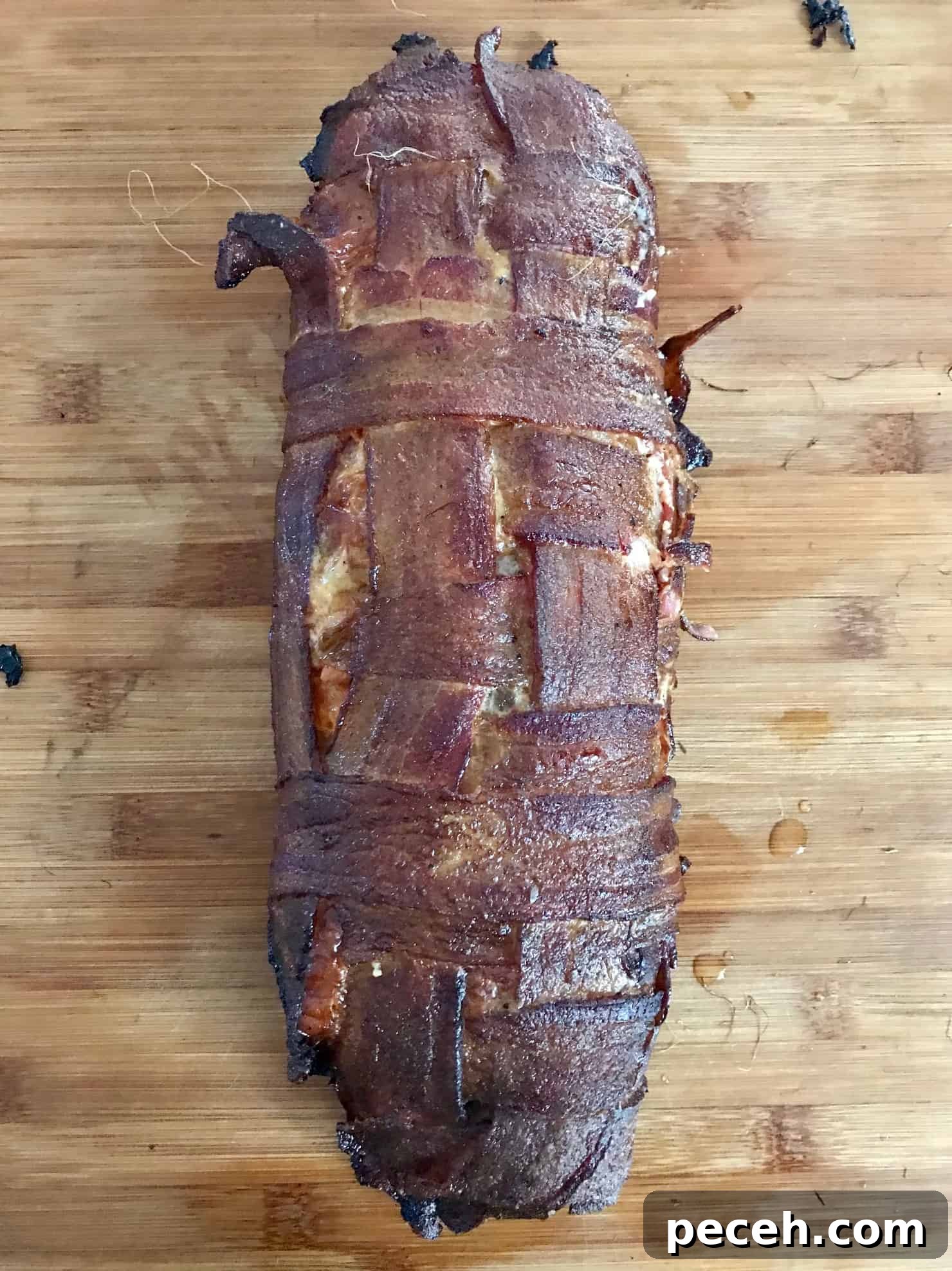 Bacon Explosion Pizza Roll: The Original Pizza Fatty Recipe 8 Pizza Bacon Explosion smoked sitting on wooden cutting board overhead shot