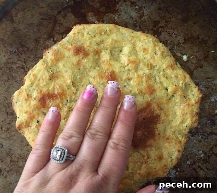 Fathead Pizza Dough Recipe for Crispy Low-Carb Crust 3 fathead pizza with hand over it to show size